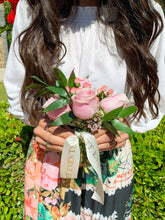 Load image into Gallery viewer, Mini flower bouquet with monogram ribbon being held by model
